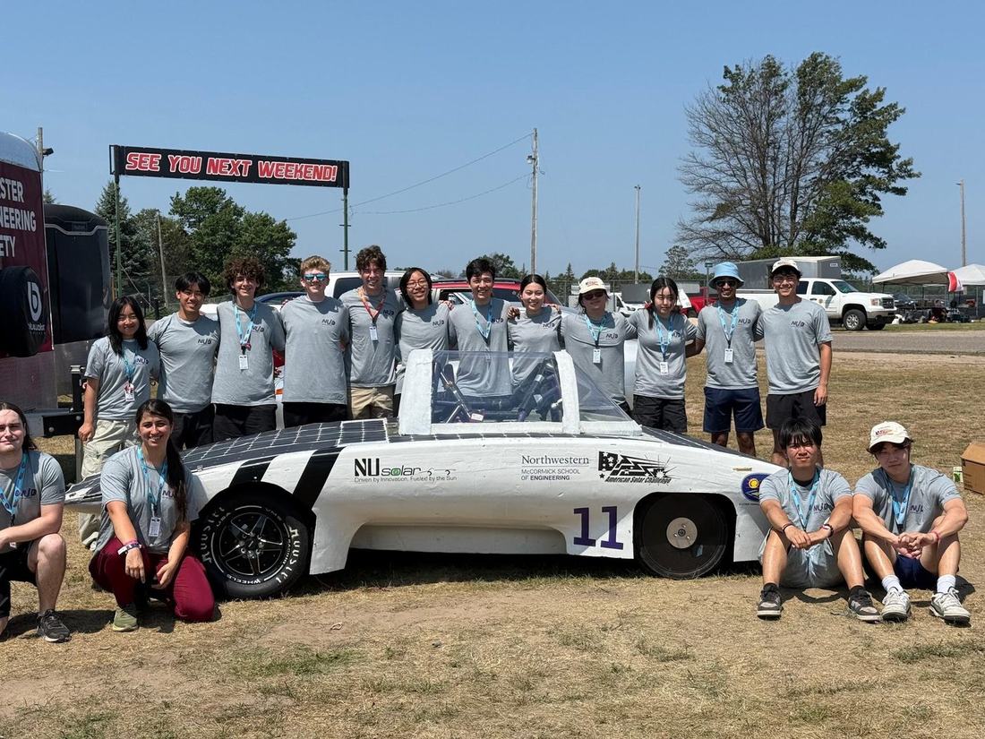 Northwestern Solar Car team with the car at competition